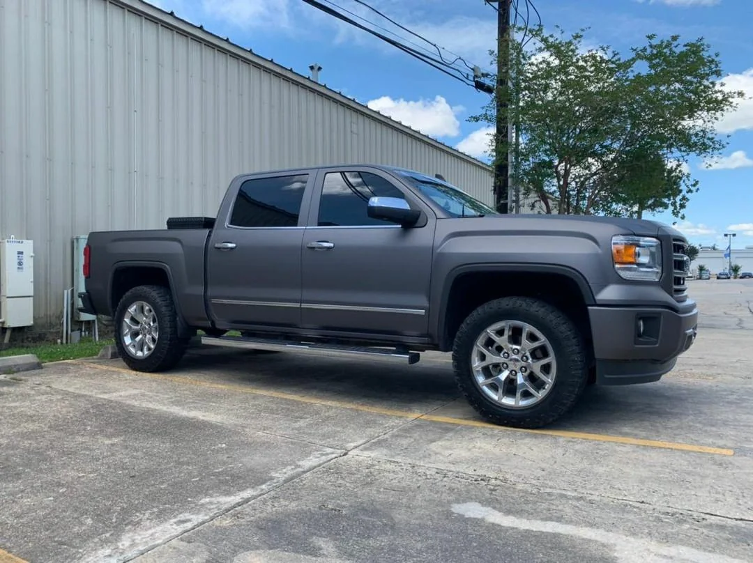 Matte-wrapped GMC with tinted windows by Exclusive Tint&Audio, Zachary LA